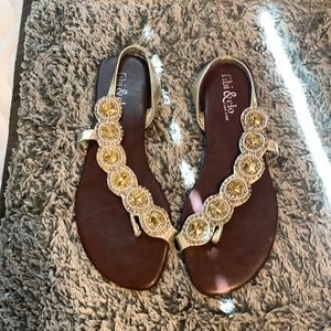 9  brown flats with silver straps and yellow jewels